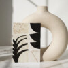 Non-woven wallpaper sample with abstract black shapes on an ecru background - Maison Baluchon