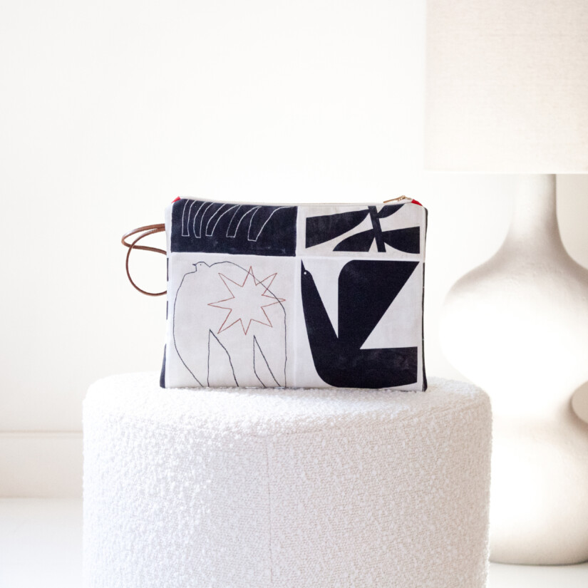 Large clutch in black modernist-inspired fabric on an ecru background