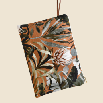 Large zippered pouch with a floral pattern of protea flowers on a Terracotta background