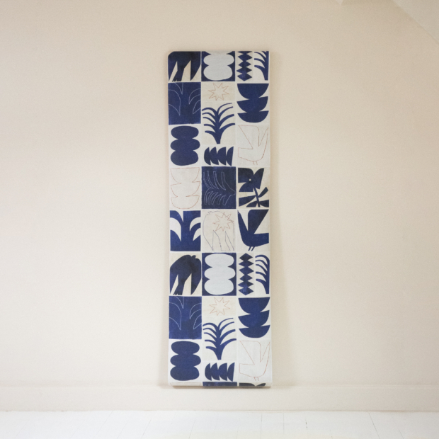 Modernist-inspired non-woven wallpaper with abstract klein blue shapes on an ecru background