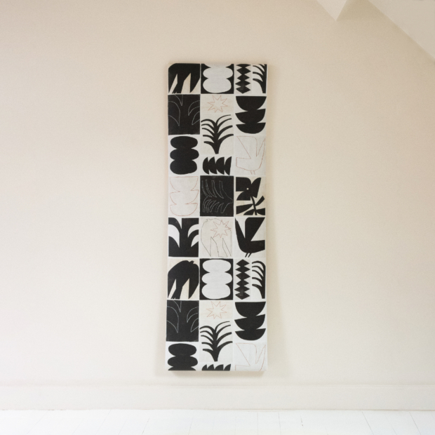 Modernist collection non-woven wallpaper with abstract black designs on an ecru background