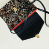 Sauvage N°24 bag with a bird feather print