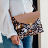 An elegant handbag with feather patterns